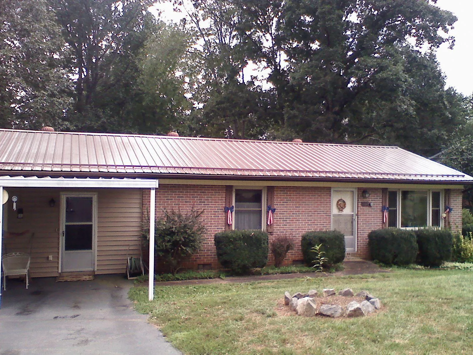 Bronze metal roof and carport on a brick ranch home — Roof Repair work by our crew in Bremo Bluff